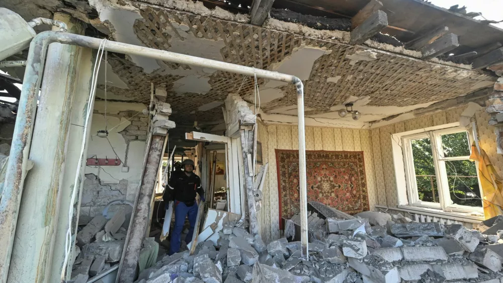 Rescuers inspect a house heavily damaged by a Russian air strike, amid Russia's attack on Ukraine, in Zaporizhzhia, Ukraine October 10, 2024. REUTERS/Stringer