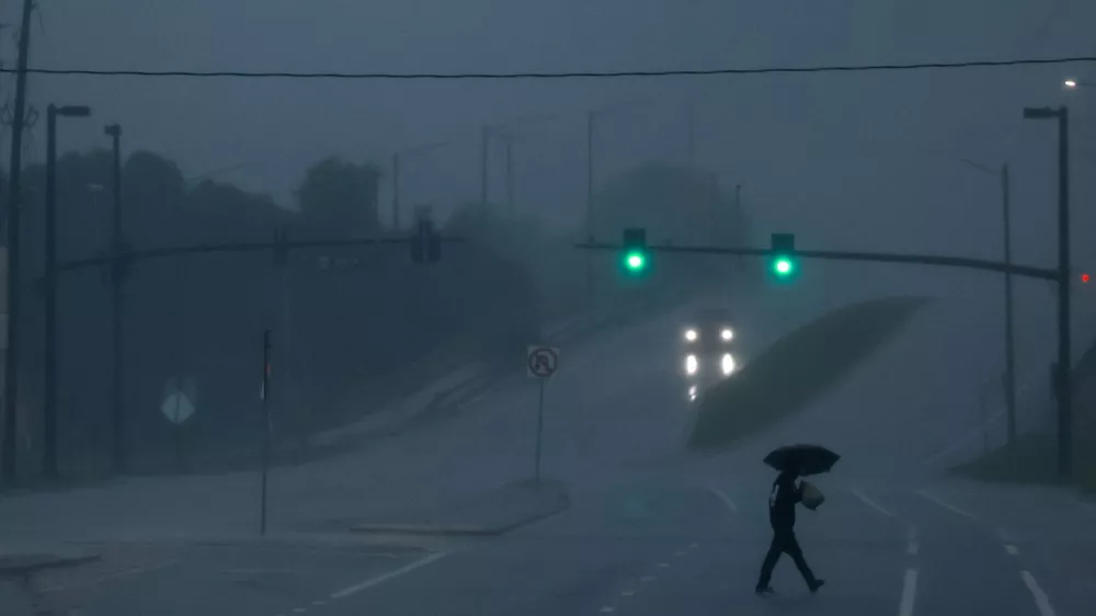 FILE PHOTO: A man walks down an avenue as Hurricane Milton approaches, in Orlando, Florida, U.S., October 9, 2024. REUTERS/Jose Luis Gonzalez/File Photo