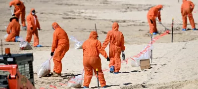 Workers in protective clothing clean up unknown debris washed up on Coogee Beach, Sydney, Australia October 17, 2024. AAP Image/Dan Himbrechts via REUTERS ATTENTION EDITORS - THIS IMAGE WAS PROVIDED BY A THIRD PARTY. NO RESALES. NO ARCHIVE. AUSTRALIA OUT. NEW ZEALAND OUT. NO COMMERCIAL OR EDITORIAL SALES IN NEW ZEALAND. NO COMMERCIAL OR EDITORIAL SALES IN AUSTRALIA.