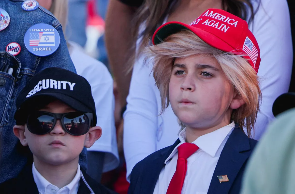 Boys wear Security and Make America Great Again hats during Republican presidential nominee and former U.S. President Donald Trump's Make America Great Again Rally in Latrobe, Pennsylvania, U.S. October 19, 2024. REUTERS/Brian Snyder  TPX IMAGES OF THE DAY