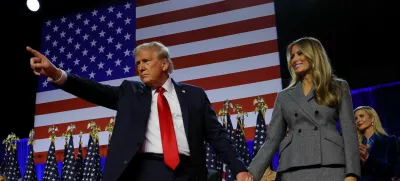 Republican presidential nominee and former U.S. President Donald Trump gestures as he holds hands with his wife Melania during his rally, at the Palm Beach County Convention Center in West Palm Beach, Florida, U.S., November 6, 2024. REUTERS/Brian Snyder   TPX IMAGES OF THE DAY
