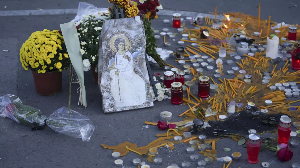 An Orthodox icon and candles left at the site for the victims after an outdoor roof collapsed at a train station on Friday, in Novi Sad, Serbia, Saturday, Nov. 2 2024. (AP Photo/Darko Vojinovic)