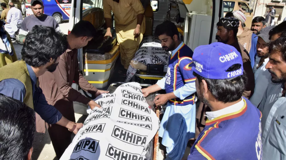 Volunteers and relatives load bodies of victims of a bomb explosion at railway station, into an ambulance after receiving from a hospital, in Quetta, southwestern Pakistan, Saturday, Nov. 9, 2024. (AP Photo/Arshad Butt)