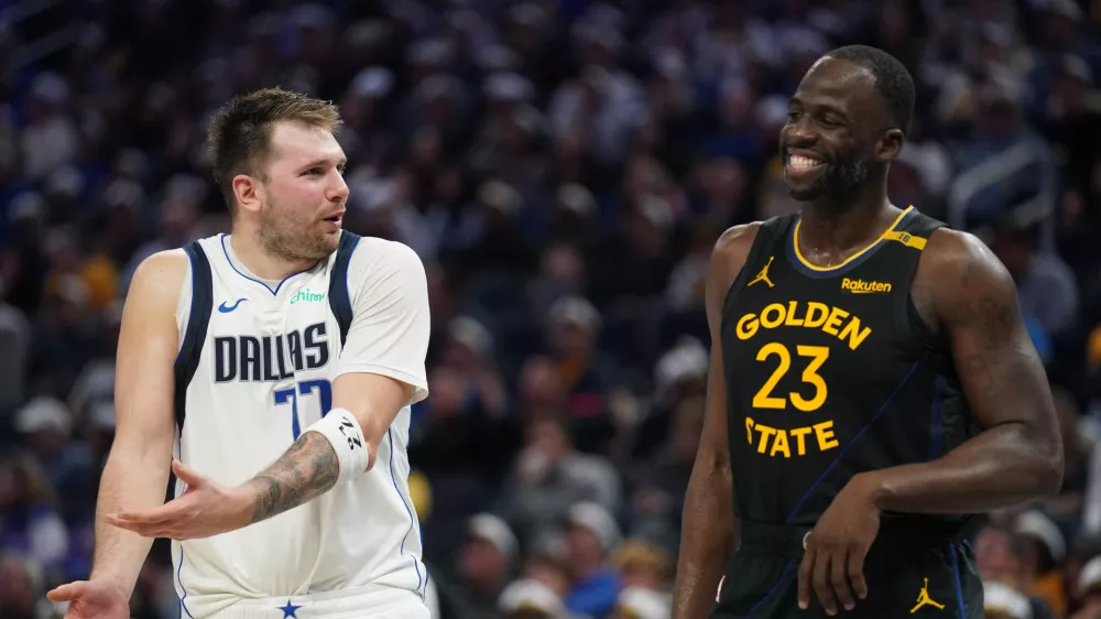 Nov 12, 2024; San Francisco, California, USA; Dallas Mavericks guard Luka Doncic (77) talks with Golden State Warriors forward Draymond Green (23) after being called for a foul in the fourth quarter at the Chase Center. Mandatory Credit: Cary Edmondson-Imagn Images