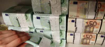 Euro bills are pictured in the safe of an Austrian bank in Vienna April 10, 2013. Austrian Finance Minister Maria Fekter will fight "like a lion" to defend the country's banking secrecy, she told a newspaper on Monday, promising to veto any steps that endanger the centuries-old tradition. Austria taxes interest income at source and sends the proceeds back to the depositor's home country without revealing any names, a system it defends as being more efficient than exchanging personal information with foreign governments. REUTERS/Heinz-Peter Bader (AUSTRIA - Tags: BUSINESS)