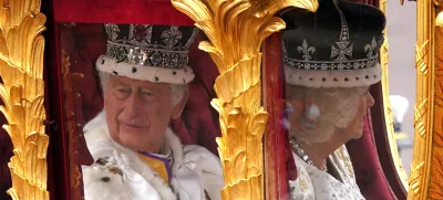 06 May 2023, United Kingdom, London: King Charles III (L) and Queen Camilla are carried in the Gold State Coach, pulled by eight Windsor Greys, in The Coronation Procession as they return along The Mall to Buckingham Palace, London, following their coronation ceremony. Photo: Niall Carson/PA Wire/dpa
