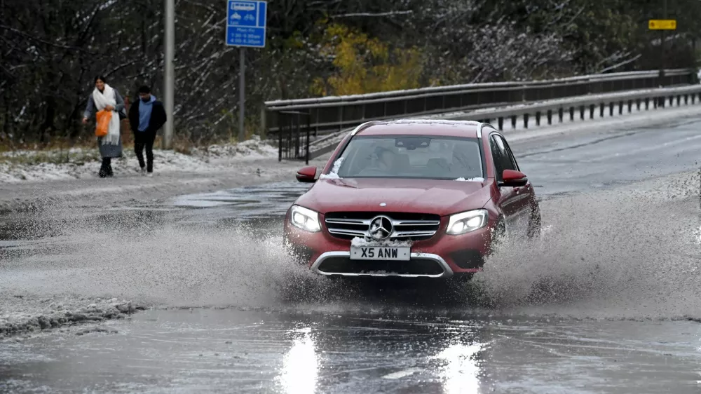A car drives through water along the A90, as a result of Storm Bert, in Cramond near Edinburgh, Scotland, Britain, November 23, 2024. REUTERS/Lesley Martin