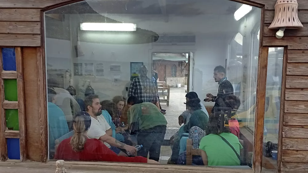 Survivors rest at a coffee shop in Marsa Alam, Egypt, Monday, Nov. 25, 2024 after a tourist yacht sank in the Red Sea following warnings about rough seas. (AP Photo)