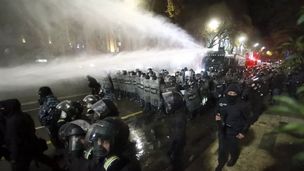 Police use a water cannon to prevent protesters pouring into the streets following Georgian Prime Minister Irakli Kobakhidze's announcement, rallying outside the parliament building in Tbilisi, Georgia, on Friday, Nov. 29, 2024. (AP Photo/Zurab Tsertsvadze)
