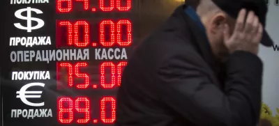 ﻿Signs advertising currencies light next to the exchange office in Moscow, Russia, Tuesday, Dec. 16, 2014. After a massive overnight rate hike by Russia's Central Bank, the ruble staged a two-hour rally Tuesday morning before rolling back to new historic lows. The surprise Central Bank decision to raise the rate to 17 percent from 10.5 percent came in the early hours on Tuesday in a desperate attempt to prop up the troubled currency. It's the biggest interest rate hike since 1998, the year when Russia defaulted on its sovereign bonds.(AP Photo / Alexander Zemlianichenko)
