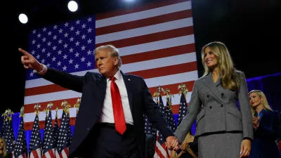 Republican presidential nominee and former U.S. President Donald Trump gestures as he holds hands with his wife Melania during his rally, at the Palm Beach County Convention Center in West Palm Beach, Florida, U.S., November 6, 2024. REUTERS/Brian Snyder   TPX IMAGES OF THE DAY