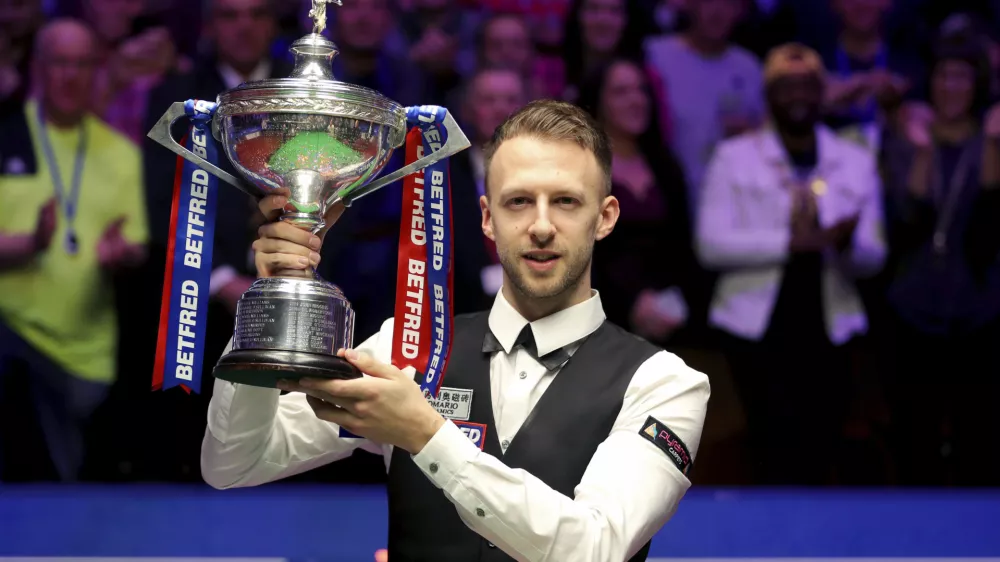 ﻿Britain's Judd Trump lifts the trophy after winning the 2019 Snooker World Championship after beating Scotland's John Higgins, at The Crucible, in Sheffield, England, Monday May 6, 2019. (Richard Sellers/PA via AP)