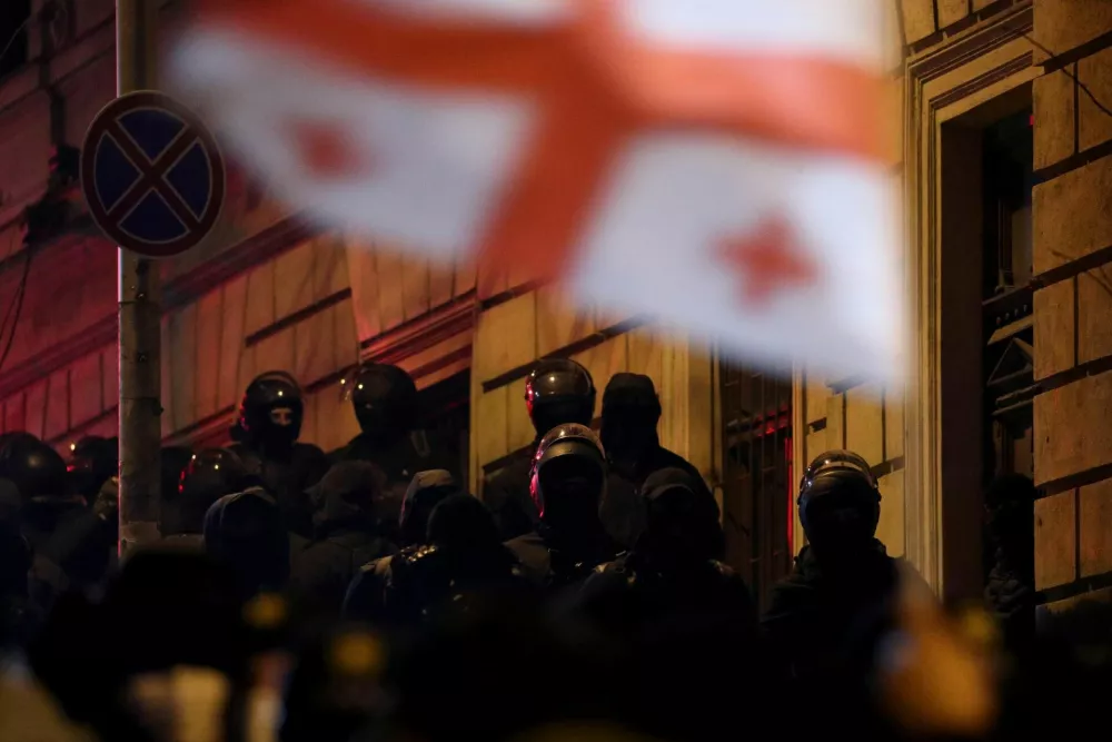 Police officers hold their positions as supporters of Georgia's opposition parties hold a rally to protest against the government's decision to suspend talks on joining the European Union, in Tbilisi, Georgia December 5, 2024. REUTERS/Irakli Gedenidze