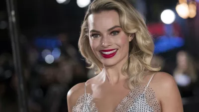 ﻿FILE - In this Monday, Dec. 10, 2018, file photo, actress Margot Robbie poses for photographers upon her arrival at the premiere of the film "Mary Queen of Scots," in London. Robbie will bring the Barbie doll to life in a live-action film. Mattel and Warner Bros. Pictures announced Tuesday, Jan. 8, 2019, that Robbie will star as the iconic doll in the franchiseâ€™s first-ever live-action film. The 28-year-old â€śSuicide Squadâ€ť actress will also co-produce the film under her LuckyChap Entertainment banner. (Photo by Vianney Le Caer/Invision/AP, File)