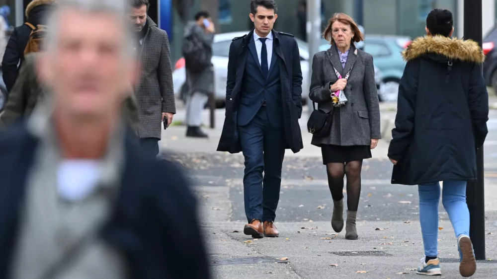 Frenchwoman Gisele Pelicot, the victim of an alleged mass rape orchestrated by her husband Dominique Pelicot at their home in the southern French town of Mazan, arrives with her lawyers Stephane Babonneau and Antoine Camus in court as prosecutors say what sentences they are seeking in the trial for Dominique Pelicot and 50 co-accused, at the courthouse in Avignon, France, November 25, 2024. REUTERS/Alexandre Dimou