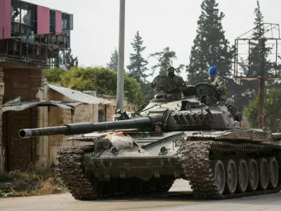 FILE PHOTO: Rebels led by the Islamist militant group Hayat Tahrir al-Sham drive a military vehicle in al-Rashideen, Aleppo province, Syria November 29, 2024. REUTERS/Mahmoud Hasano/File Photo