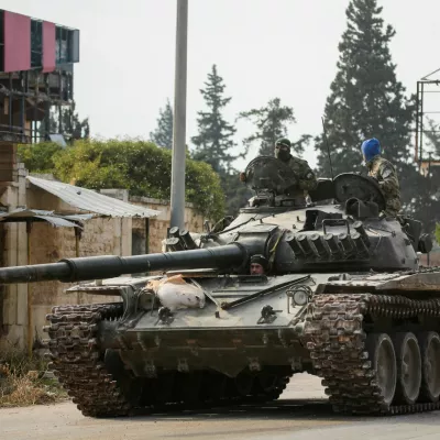 FILE PHOTO: Rebels led by the Islamist militant group Hayat Tahrir al-Sham drive a military vehicle in al-Rashideen, Aleppo province, Syria November 29, 2024. REUTERS/Mahmoud Hasano/File Photo