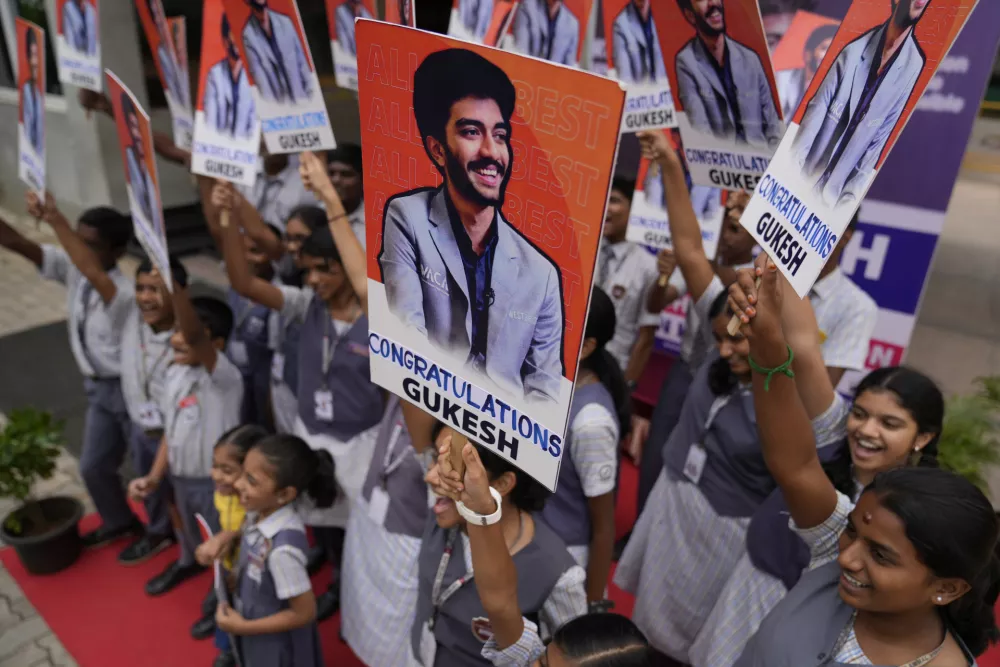 Students at Gukesh Dommaraju's school in Chennai celebrate after Gukesh became the youngest World Chess Champion, in Chennai, India, Friday, Dec. 13, 2024. (AP Photo/Mahesh Kumar A.)