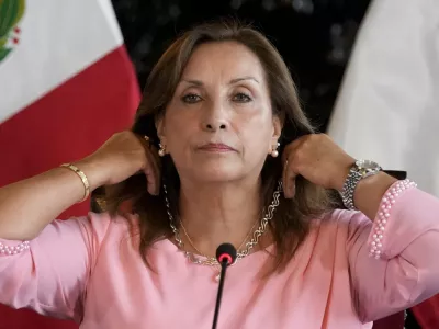 FILE - Peru's President Dina Boluarte shows her jewelry during a press conference at Government Palace in Lima, Peru, April 5, 2024. (AP Photo/Martin Mejia, File)