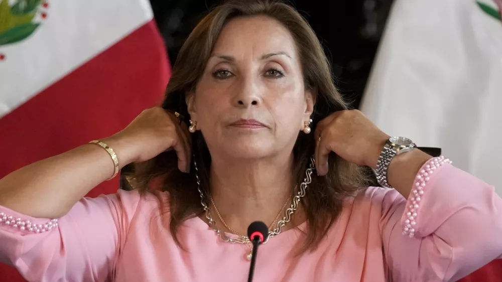 FILE - Peru's President Dina Boluarte shows her jewelry during a press conference at Government Palace in Lima, Peru, April 5, 2024. (AP Photo/Martin Mejia, File)