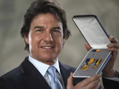 Tom Cruise receives a Navy Distinguished Public Service Award from The United States Secretary of the Navy Carlos Del Toro presents at the Longcross South Studios, in Runnymede, Surrey, England, Tuesday, Dec. 17, 2024. (AP Photo/Kin Cheung)