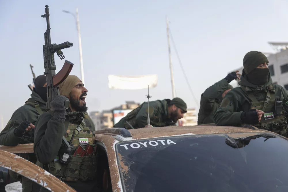 Syrian opposition fighters ride along the streets in the aftermath of the opposition's takeover of Hama, Syria, Friday, Dec. 6, 2024. (AP Photo/Ghaith Alsayed)