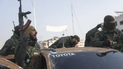 Syrian opposition fighters ride along the streets in the aftermath of the opposition's takeover of Hama, Syria, Friday, Dec. 6, 2024. (AP Photo/Ghaith Alsayed)