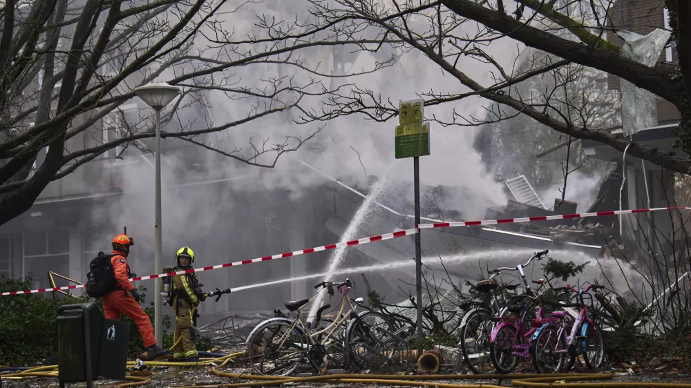 Firefighters work at the sight of an explosion at an apartment block in The Hague, Saturday, Dec. 7, 2024. (AP Photo/Phil Nijhuis)