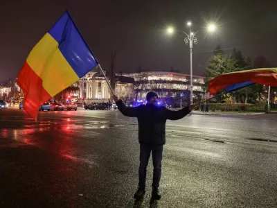 A man waves Romanian flags at Victory Square, after the annulment of the presidential election result, in Bucharest, Romania, December 6, 2024. REUTERS/Louisa Gouliamaki