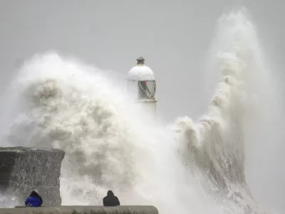 Waves crash during storm Darragh over the seafront in Porthcawl in Wales, Saturday, Dec. 7, 2024. (Ben Birchall/PA via AP)