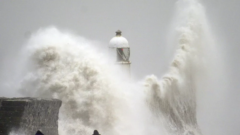 Waves crash during storm Darragh over the seafront in Porthcawl in Wales, Saturday, Dec. 7, 2024. (Ben Birchall/PA via AP)