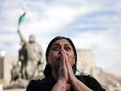 A woman reacts, as people celebrate after Syrian rebels announced that they have ousted President Bashar al-Assad, in Majdal Shams, a Druze village in the Israeli-occupied Golan Heights, December 8, 2024. REUTERS/Stoyan Nenov