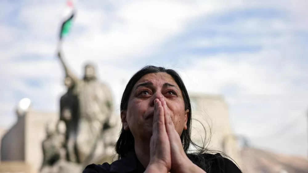 A woman reacts, as people celebrate after Syrian rebels announced that they have ousted President Bashar al-Assad, in Majdal Shams, a Druze village in the Israeli-occupied Golan Heights, December 8, 2024. REUTERS/Stoyan Nenov