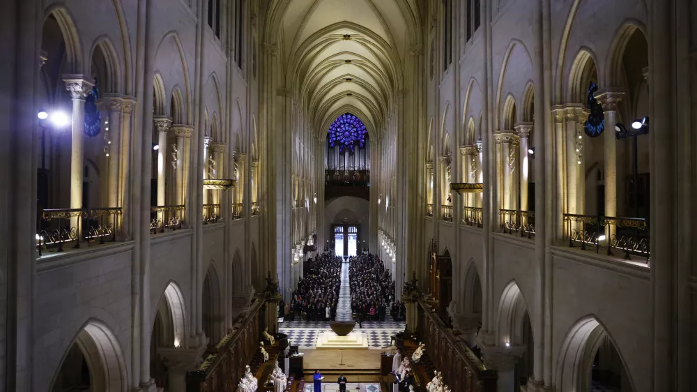 Guests attend an inaugural Mass, with the consecration of the high altar, at the Notre-Dame de Paris Cathedral, five-and-a-half years after a fire ravaged the Gothic masterpiece, as part of ceremonies to mark the Cathedral's reopening after its restoration, in Paris, France, Sunday, Dec. 8, 2024. (Sarah Meyssonnier/Pool Photo via AP)