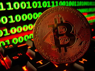 FILE PHOTO: Bitcoin cryptocurrency representation is pictured on a keyboard in front of binary code in this illustration taken September 24, 2021. REUTERS/Dado Ruvic/Illustration/File Photo