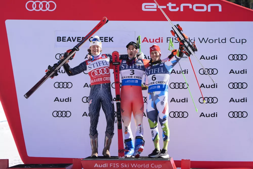 From left, second place finisher Brazil's Lucas Pinheiro Braathen, first place finisher Switzerland's Thomas Tumler, and third place finisher Slovenia's Zan Kranjec celebrate after a men's World Cup giant slalom skiing race, Sunday, Dec. 8, 2024, in Beaver Creek. (AP Photo/John Locher)