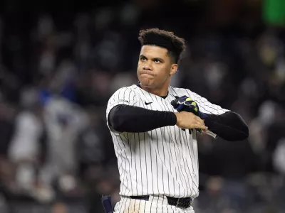 FILE - New York Yankees' Juan Soto takes off his batting gloves after grounding out against the New York Yankees to end the third inning in Game 3 of the baseball World Series, on Oct. 28, 2024, in New York. (AP Photo/Godofredo A. Vásquez, File)