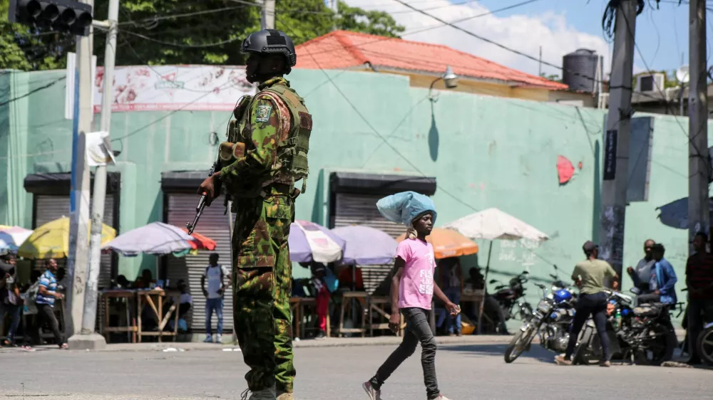 FILE PHOTO: A Kenyan police officer patrols as the country is facing emergency food insecurity while immersed in a social and political crisis, in Port-au-Prince, Haiti October 3, 2024. REUTERS/Jean Feguens Regala//File Photo