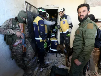 Members of the Syrian civil defence group, known as the White Helmets, search for prisoners at Sednaya prison, with rebel fighters around, after rebels seized the capital and announced that they have ousted President Bashar al-Assad in Sednaya, Syria, December 9, 2024. REUTERS/Amr Abdallah Dalsh    TPX IMAGES OF THE DAY