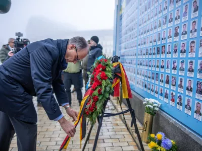 08 December 2024, Ukraine, Kiev: Friedrich Merz, CDU candidate for German chancellor and federal CDU chairman, stands at the Wall of Remembrance for the soldiers who died in the war on St. Michael's Square. Merz is spending a day in the Ukrainian capital. Photo: Michael Kappeler/dpa