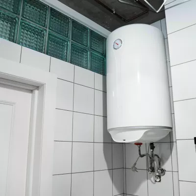 2H4M5HW Modern gas tanked boiler in bathroom. Household budget water heater hanging on the wall in boiler room. Common electric storage tank water heater