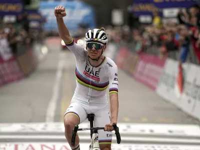 Reigning World Champion Slovenia's Tadej Pogacar celebrates winning Il Lombardia, Tour of Lombardy cycling race, in Como, Italy, Saturday, Oct. 12, 2024. (Marco Alpozzi/LaPresse via AP)