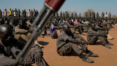 FILE PHOTO: South Sudan People's Defence Forces (SSPDF), South Sudan Opposition Alliance (SSOA), and The Sudan People's Liberation Movement in Opposition (SPLM-IO) soldiers gather at the training site for the joint force to protect VIPs in Gorom outside Juba, South Sudan February 17, 2020. REUTERS/Andreea Campeanu/File Photo