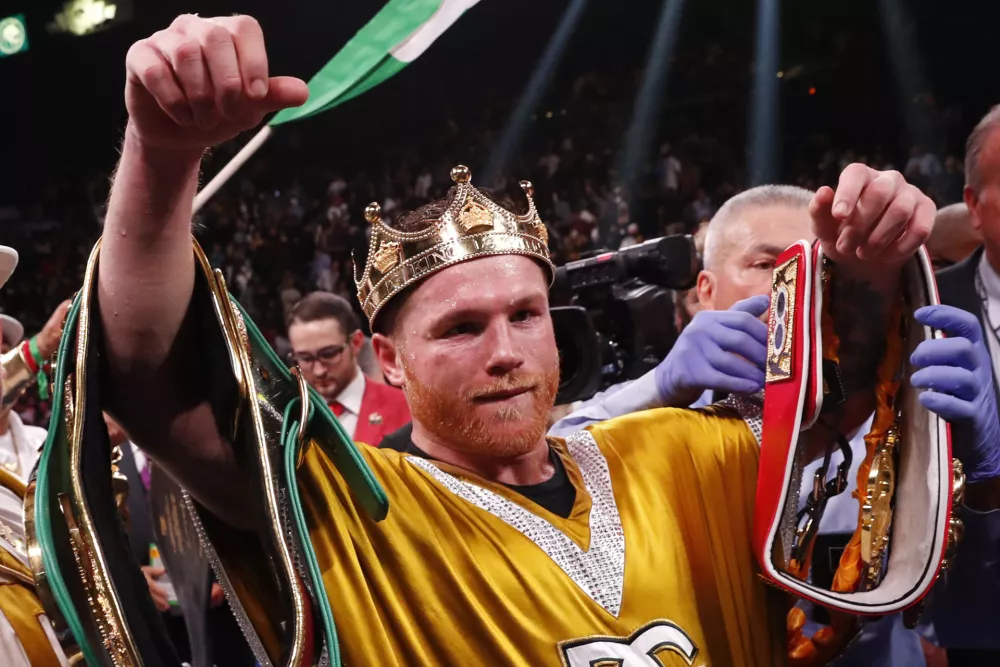 ﻿Canelo Alvarez, of Mexico, celebrates after defeating Caleb Plant in a super middleweight title unification fight Saturday, Nov. 6, 2021, in Las Vegas. (AP Photo/Steve Marcus)