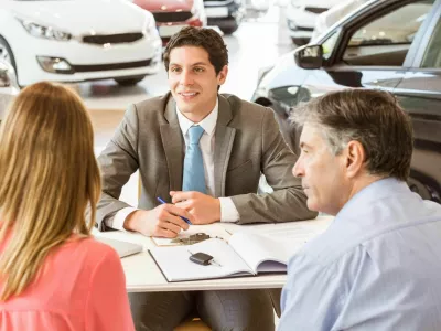 F5445N Smiling couple buying a new car