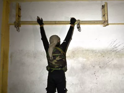 25 December 2024, Syria, Damascus: A soldier demonstrates how prisoners were tortured at the Syrian Military Intelligence Palestine Branch 235 that was a jail for political prisoners during a brutal regime where countless men disappeared in Damascus. Photo: Carol Guzy/ZUMA Press Wire/dpa