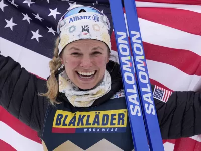 Jessie Diggins, of the United States, celebrates after winning the Women's Cross Country Interval Start 10 KM Free event at the Nordic World Championships in Planica, Slovenia, Tuesday, Feb. 28, 2023. (AP Photo/Matthias Schrader)