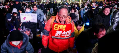 A protester carries a sign that reads "Impeach Yoon Suk Yeol" during a rally calling for the impeachment of South Korean President Yoon Suk Yeol, who declared martial law, which was reversed hours later, in front of the National Assembly in Seoul, South Korea, December 10, 2024. REUTERS/Kim Hong-Ji