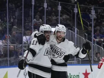 Los Angeles Kings' Adrian Kempe (9) celebrates with Anze Kopitar (11) after scoring a goal during the first period of an NHL hockey game against the New York Islanders Tuesday, Dec. 10, 2024, in Elmont, N.Y. (AP Photo/Frank Franklin II)