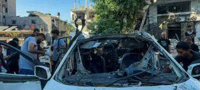 Palestinians inspect a vehicle where Al Jazeera TV said its reporter Ismail al-Ghoul and cameraman Ramy El Rify were killed in an Israeli strike, in Gaza City July 31, 2024. REUTERS/Ayman Al Hassi   TPX IMAGES OF THE DAY